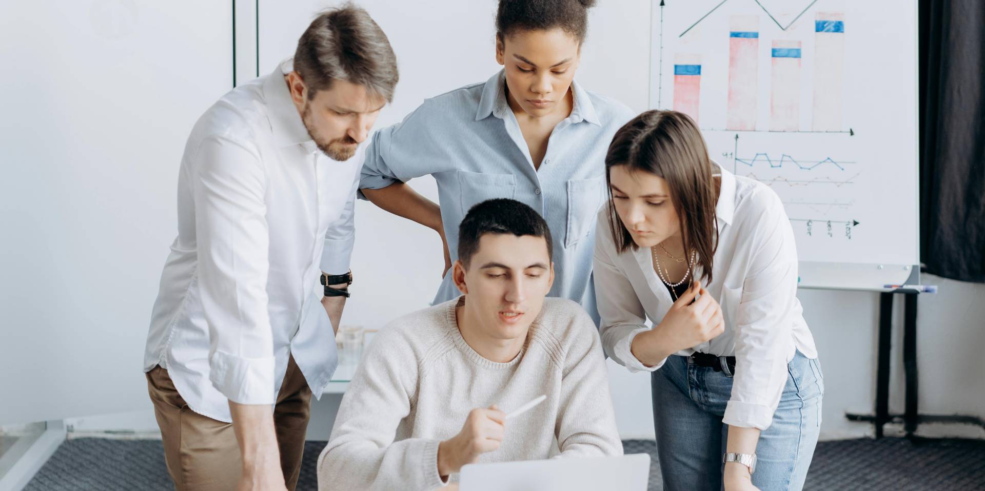 Business owners gathered around a laptop