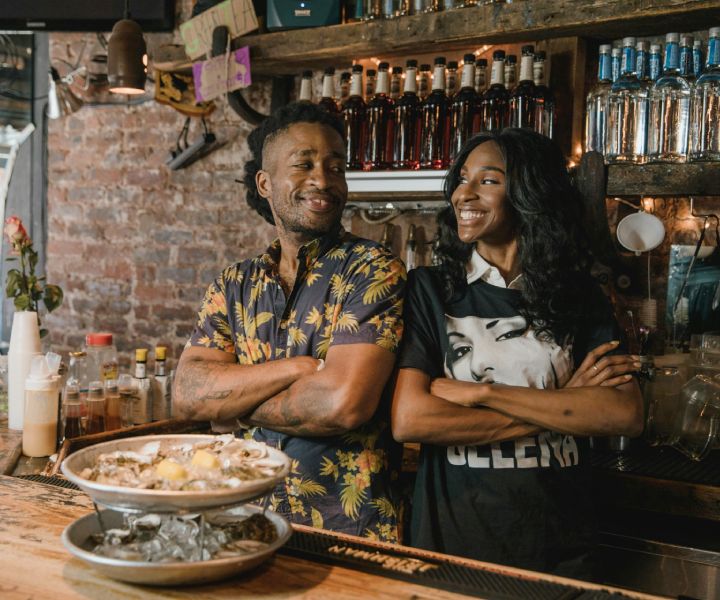 Two happy restaurant owners behind the counter