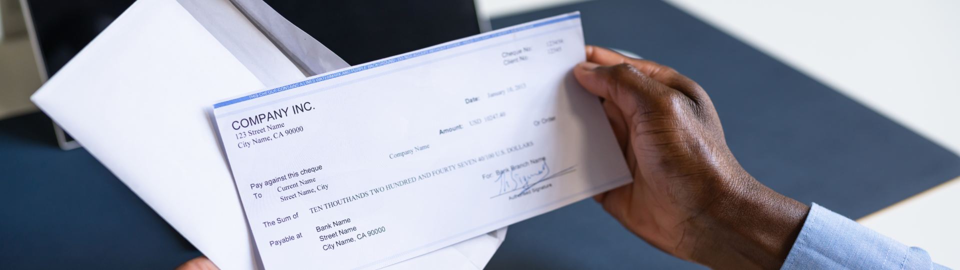 Hands opening up a paycheck