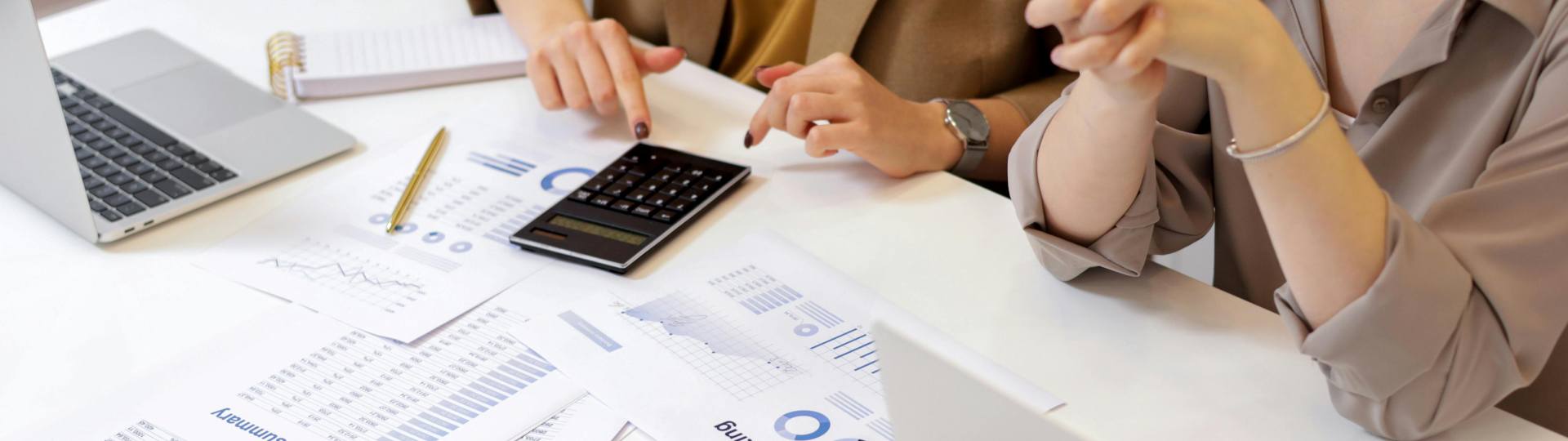Two accountants looking over paperwork at a desk