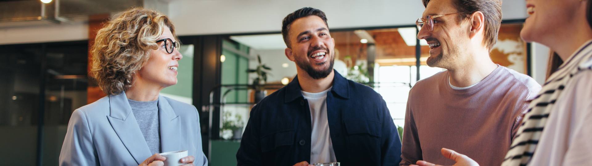 Group of office workers mingling over coffee