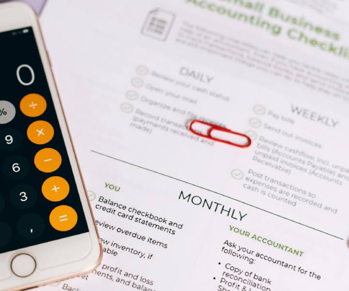 Financial paperwork and a phone on the desk of a Simsbury business owner